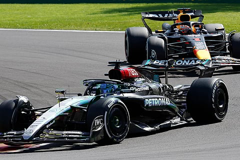 Mercedes driver George Russell steers his car ahead of Max Verstappen